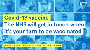 'COVID-19 vaccine. The NHS will get in touch when it is your turn to be vaccinated' is written in front of a blue background, made up of photos of NHS staff wearing masks.