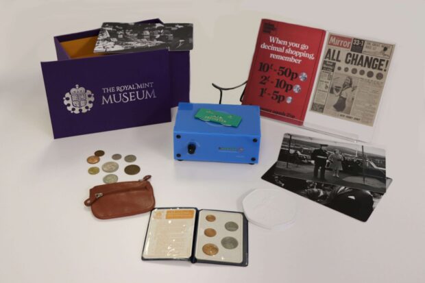 Overview of 'Museum in a Box' pre-decimalisation collection with the front page of a paper from the day of the changeover, coin chart, a small purse with coins and some pictures of the Queen.